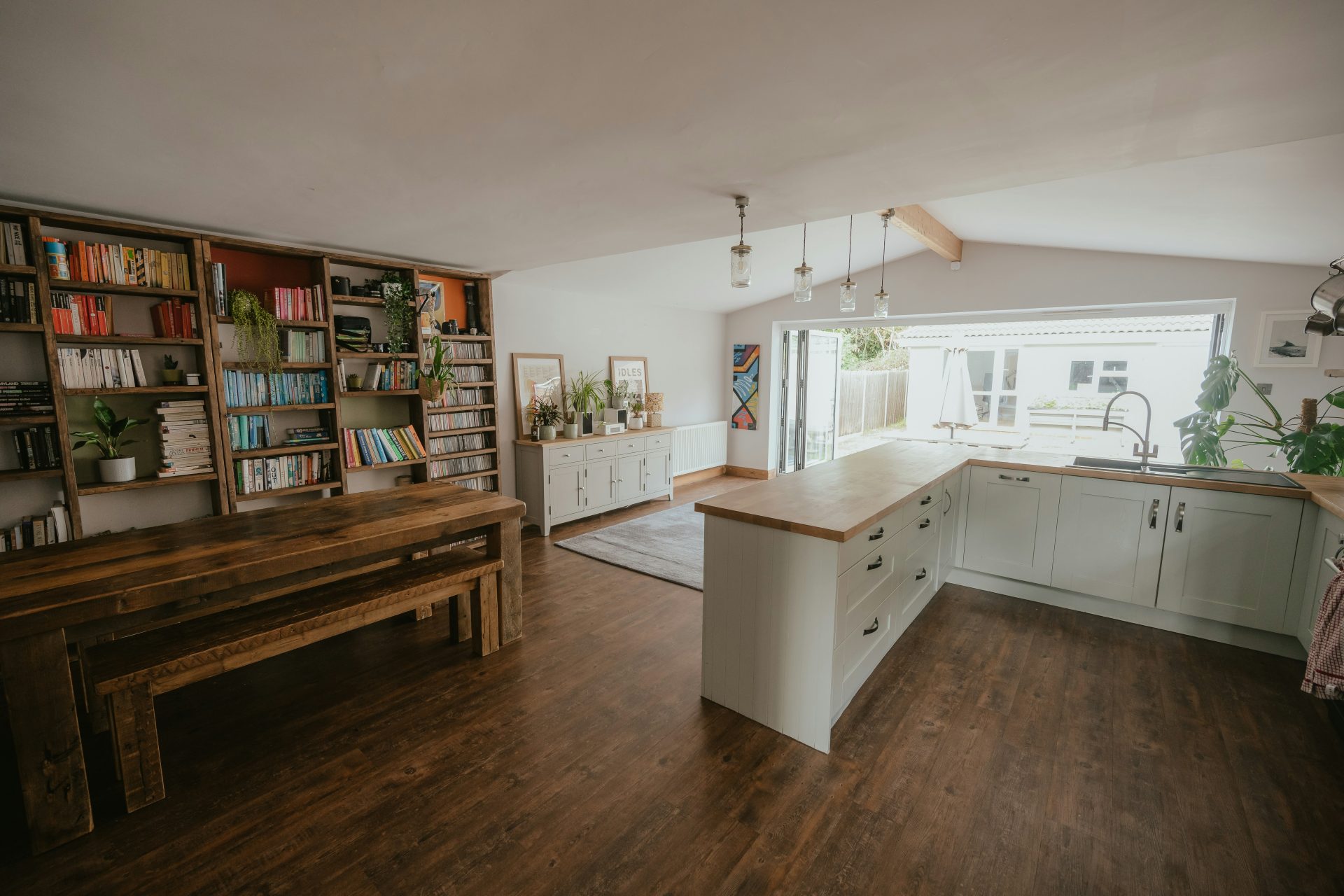 a kitchen with a book shelf